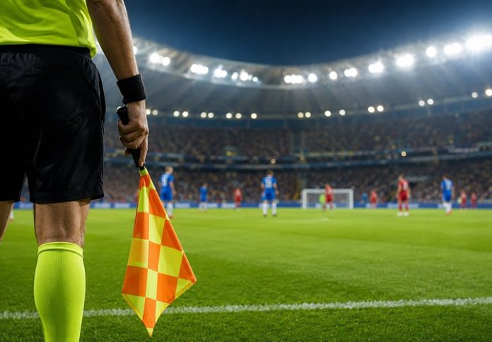 Referee peeking through stadium lights